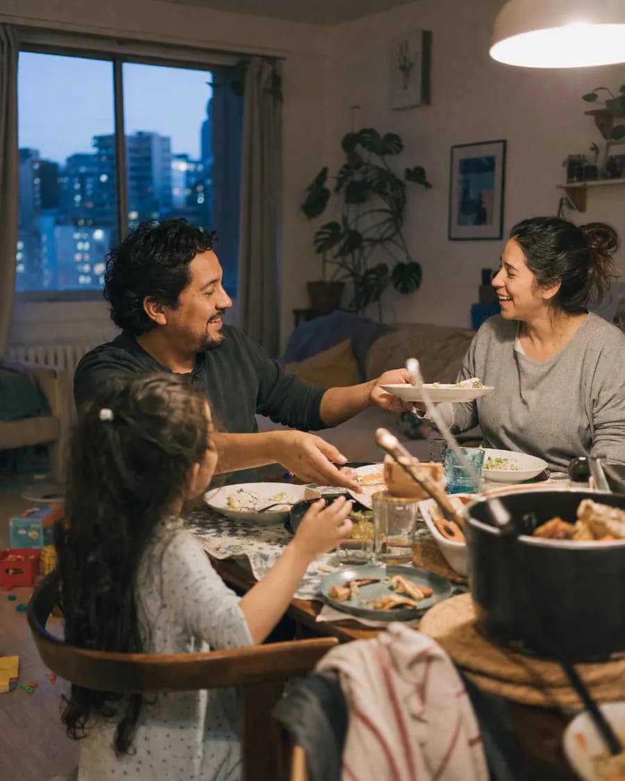 A family sharing an unposed evening meal at home.