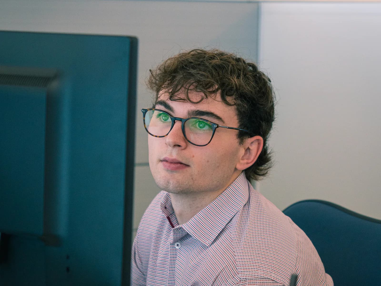 An investment professional working at a computer.